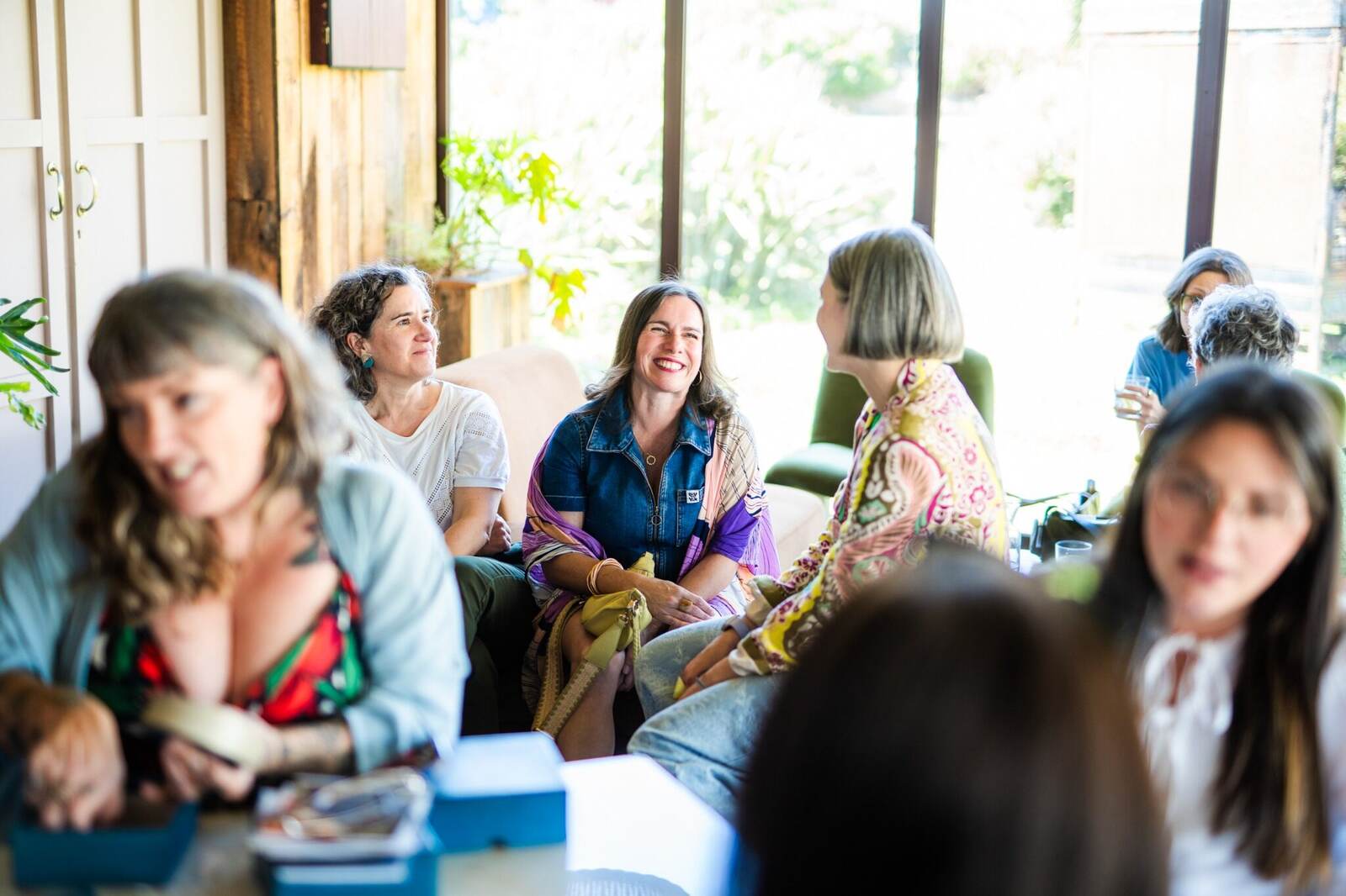 A relaxed group of guests talking together in a bright room