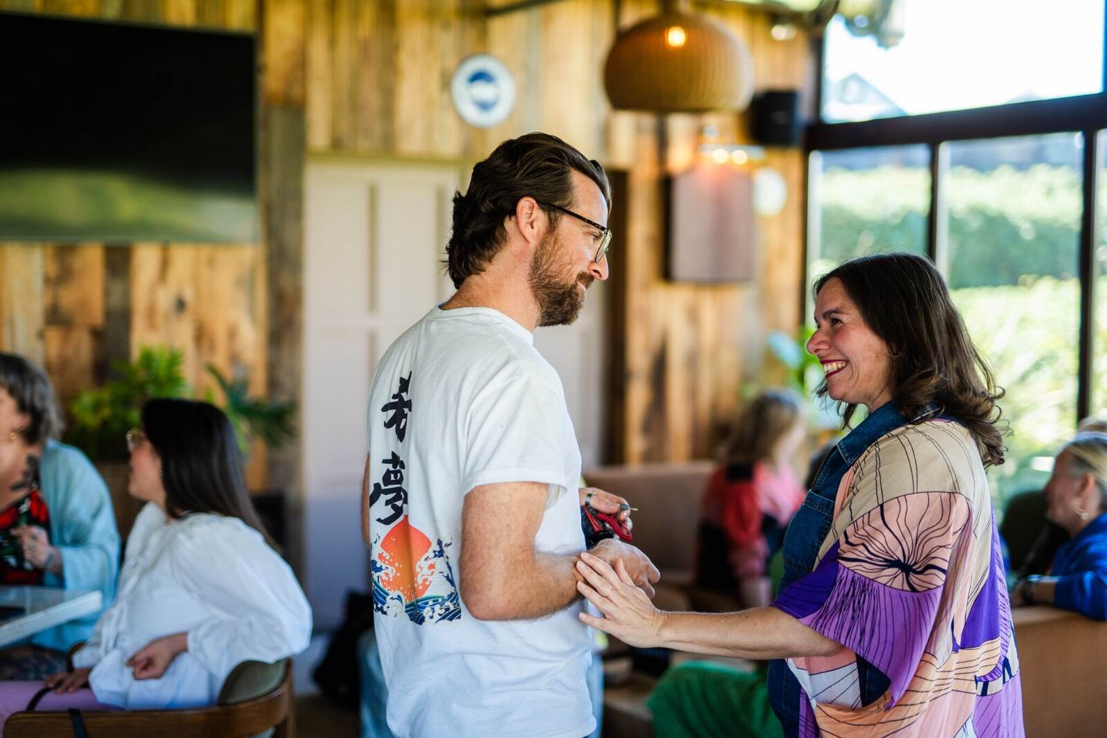 Two guests deep in conversation at a house of hopium gathering