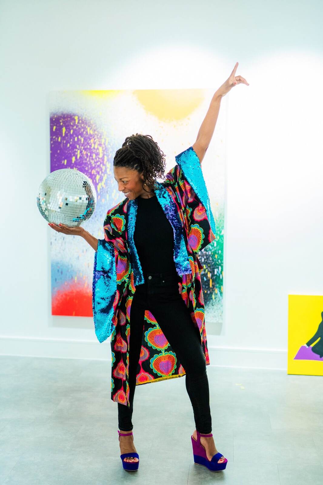 Liana Fricker holding a disco ball at Inspiration Space