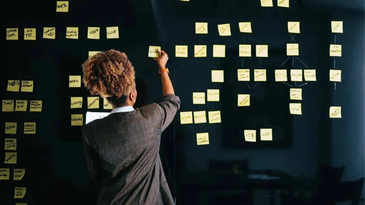 Small business owner strategizing budget-friendly marketing tactics - The Inspiration Space